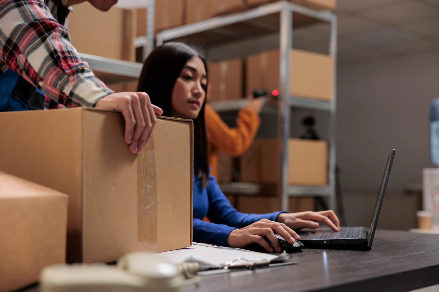 woman sitting by her desk looking at her laptop